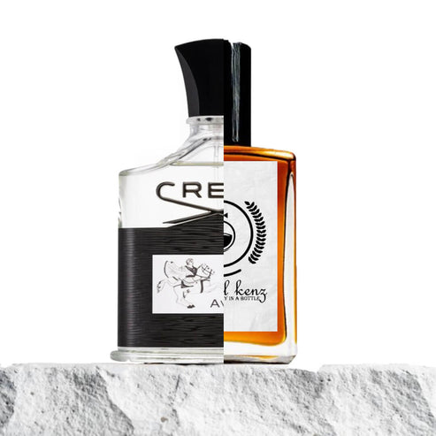 The image shows a split composition of two perfume bottles merged together. The left side of the bottle resembles the design of Creed Aventus, featuring a transparent glass bottle with black labeling and a depiction of a horseman. The right side displays the bottle of Baytulkenz Perfumes, showcasing an amber-colored liquid with a white label bearing the Baytulkenz logo and branding. Both bottles rest on a textured stone surface, creating a visually striking comparison of the two fragrances.