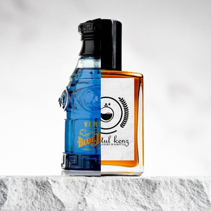 "A split image displays two perfume bottles side by side."
"On the left, a blue perfume bottle labeled Blue Jeans by Versace, with a classic, sleek design and vibrant blue color."
"The bottle has a simple, elegant shape with a bold label and gold accents."
"On the right, an amber perfume bottle with a logo, the Baytulkenz inspired version of Blue Jeans by Versace."
"The amber bottle has a warm, rich hue and features a refined design with the distinctive Baytulkenz logo."