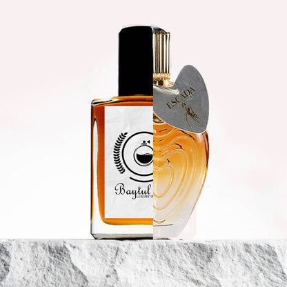 "A split image features two perfume bottles displayed side by side against a soft background."
"On the left, a bottle labeled "Baytulkenz Luxury", the inspired version of Escada Collection."
"The Baytulkenz Luxury bottle has an elegant, minimalist design with a luxurious color and refined Baytulkenz branding."
"On the right, a bottle labeled "Escada", representing the original Escada Collection fragrance."
"The Escada bottle features a sleek and sophisticated design with the iconic Escada logo."