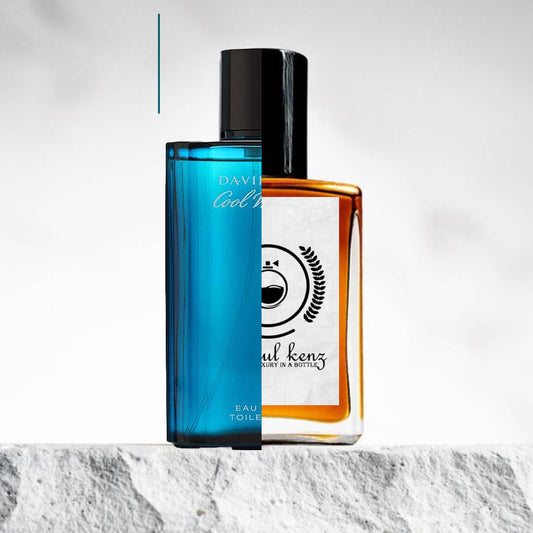 "Two perfume bottles are displayed side by side."
"On the left, a blue bottle with a sleek design, labeled Cool Water Intense by Davidoff."
"The Cool Water Intense bottle has a smooth, modern shape with a deep blue hue, exuding a fresh and invigorating feel."
"On the right, an amber bottle with a label, the Baytulkenz inspired version of Cool Water Intense by Davidoff."
"The amber bottle has a warm, rich color and a minimalist design with the distinctive Baytulkenz logo."