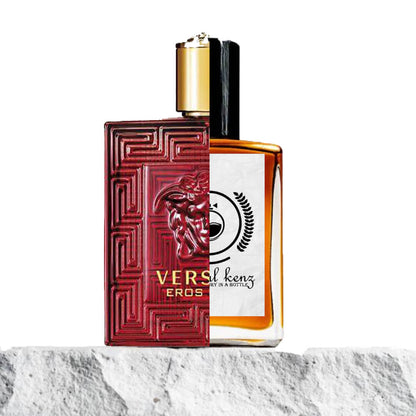 "A split image features two perfume bottles displayed side by side on a stone surface."
"On the left, a red and gold bottle labeled Versace Eros Flame, with a bold, striking design."
"The Versace Eros Flame bottle has a vibrant red color with intricate gold detailing, exuding passion and luxury."
"On the right, a clear bottle labeled "Baytulkenz", the inspired version of Versace Eros Flame."
"The Baytulkenz bottle has a minimalist, transparent design with a subtle, modern look and the Baytulkenz logo."