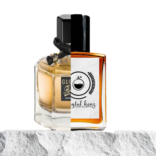 A split image of two perfume bottles. The left half shows a Gucci Flora perfume bottle with a hexagonal shape, light amber liquid inside, and a black ribbon around the cap. The right half displays a Baytulkenz Perfumes bottle with a square shape, amber liquid, and a white label featuring the Baytulkenz logo, which includes a perfume bottle symbol and the text "Baytul Kenz: Luxury in a Bottle." Both bottles sit on a white stone surface.