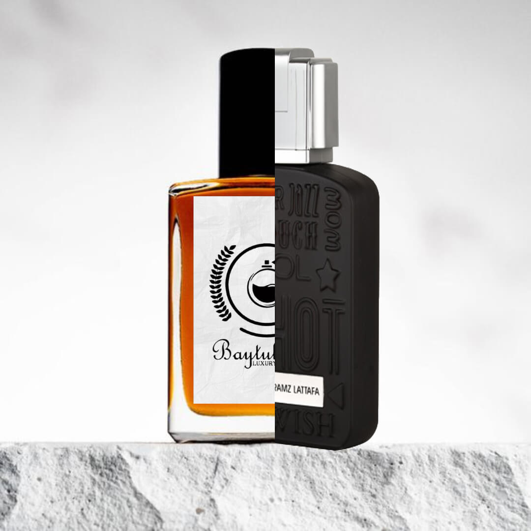 "Two perfume bottles are displayed side by side against a light background."
"On the left, an amber bottle labeled Baytulkenz, an inspired version of Lattafa Ramz Silver." 
"The amber bottle features a sleek and elegant design, mirroring the original fragrance."
"On the right, a sleek black bottle labeled Lattafa Ramz Silver,  exuding a bold and sophisticated look."
"The light background highlights the contrast between the amber and black bottles, showcasing their unique yet complementary designs."