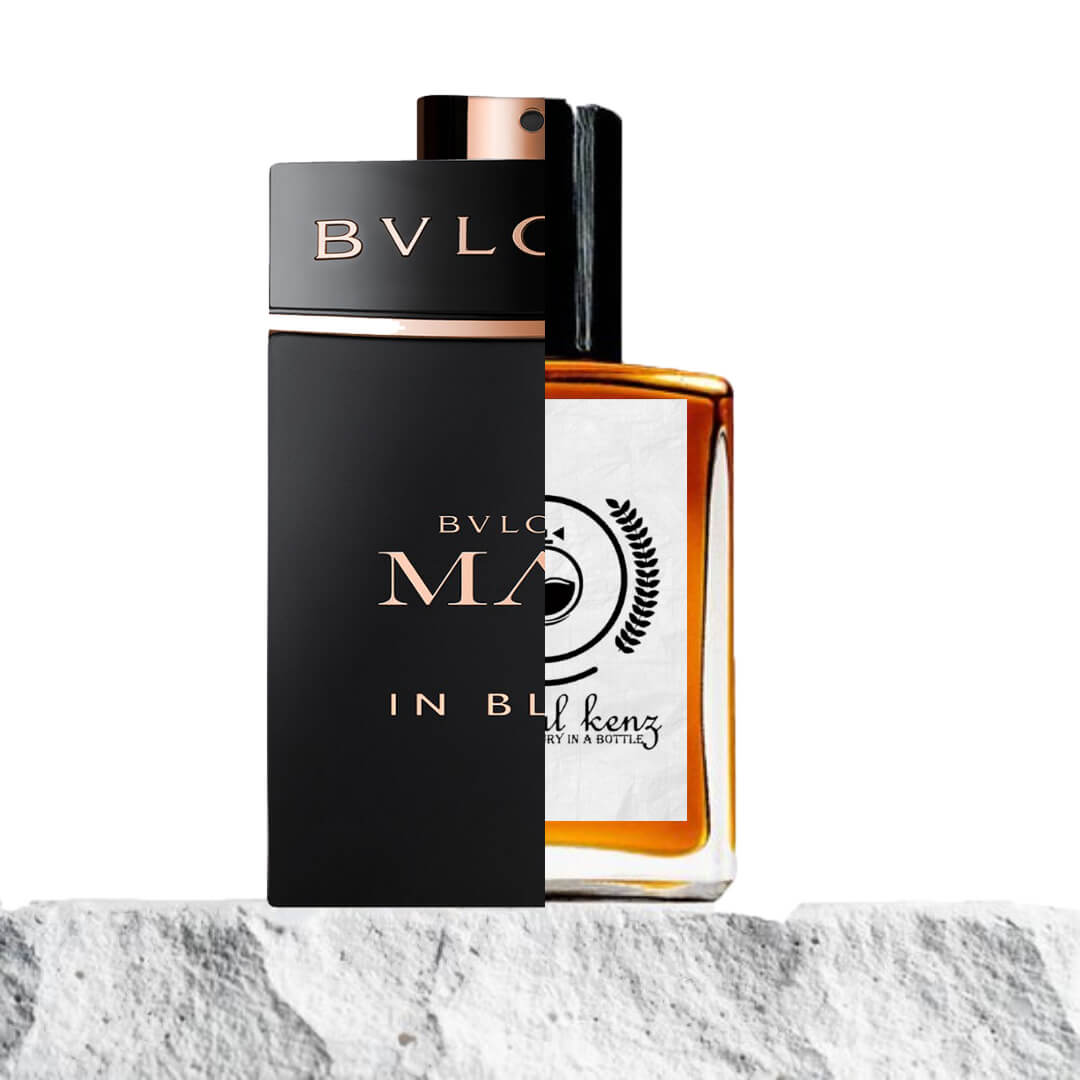 "A split image features two perfume bottles displayed side by side."
"On the left, a black bottle with gold text, labeled Bvlgari Man in Black."
"The black bottle has a sleek, bold design with a luxurious gold label, exuding sophistication and strength."
"On the right, an amber bottle with a white label, featuring the Baytulkenz logo, the inspired version of Bvlgari Man in Black."
"The amber bottle has a warm, rich color with a simple, elegant design and distinctive branding."