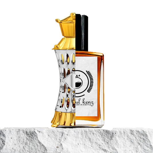 "A stylish perfume bottle with a golden top and a silver textured body, labeled Mizyaan Ajmal, exuding a luxurious and refined design."
"Beside it, the Baytulkenz inspired version of Mizyaan Ajmal, featuring an amber-colored perfume bottle with a sleek, elegant appearance."
"The Baytulkenz bottle offers a warm, sophisticated contrast to the silver and gold design of the original."
"Both bottles are displayed with a focus on their intricate designs and luxurious finishes."