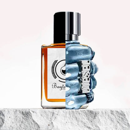 "Two contrasting perfume bottles are placed against a marbled backdrop."
"On the left, an amber-colored bottle represents the Baytulkenz inspired version of "Only the Brave Diesel," with a sleek and modern design."
"On the right, the original "Only the Brave Diesel" bottle stands in a unique blue cylindrical shape, with "Diesel" written prominently on it."
"The amber bottle offers a warm, rich tone, while the blue bottle's vibrant color creates a bold contrast."