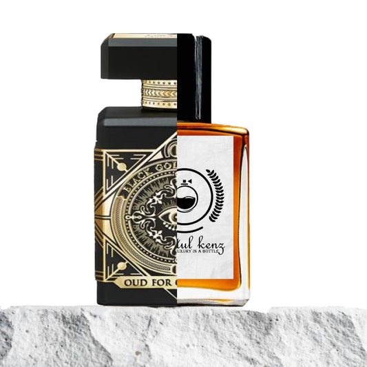 "Two luxurious perfume bottles are placed on a rocky, marble-like surface."
"On the left, a sleek black and gold bottle, labeled "Oud for Greatness," exudes an elegant, high-end design."
"On the right, an amber-colored bottle with a white label represents the Baytulkenz inspired version of "Oud for Greatness.""
"The black and gold bottle stands out with its sophisticated look, while the amber bottle offers a warm and inviting hue."