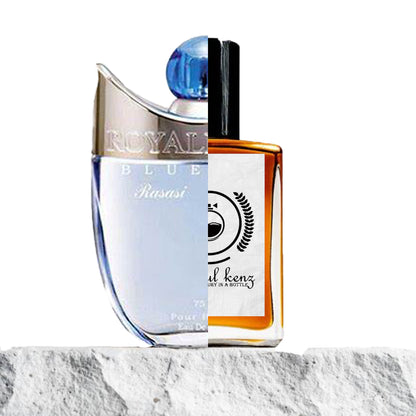 "Two perfume bottles against a white background."
"On the left, a blue and silver bottle labeled "Royale Blue Rasasi" features an elegant and modern design."
"On the right, an amber and black bottle represents the Baytulkenz inspired version of "Royale Blue Rasasi."
"The blue and silver bottle stands out with its cool, sleek appearance, while the amber and black bottle offers a warm, bold contrast."