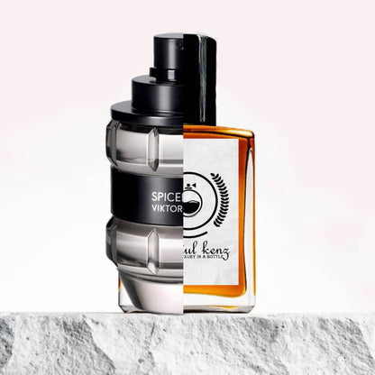 "Two perfume bottles are displayed side by side on a white background with a textured edge below."
"On the left, a black and silver-colored bottle is labeled "Spicebomb Viktor&Rolf," showcasing a sleek and contemporary design."
"On the right, an amber-colored bottle with a white label represents the Baytulkenz inspired version of "Spicebomb Viktor&Rolf."
"The black and silver bottle stands out with its bold, masculine aesthetic, while the amber bottle contrasts with its warm, inviting color."
