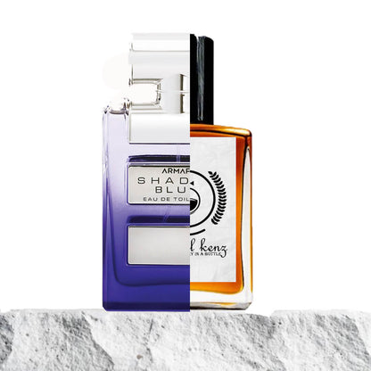 "Two perfume bottles are placed side by side against a white background."
"On the left, a lavender-colored bottle with a slightly transparent upper body is labeled "Shades Blue Armaf."
"On the right, an amber-colored bottle with a transparent body represents the Baytulkenz inspired version of "Shades Blue Armaf."
"The lavender bottle features a soft, cool tone, while the amber bottle contrasts with a warm, rich hue."