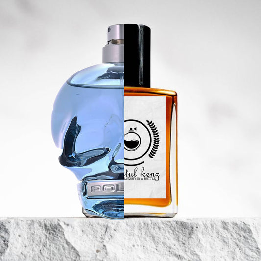 "Two different perfume bottles are placed on a white surface with a grey backdrop."
"On the left, a clear bottle with blue-colored liquid is labeled "To Be Police."
"On the right, an amber-colored bottle represents the Baytulkenz inspired version of "To Be Police."
"The clear bottle with blue liquid has a fresh, vibrant appearance, while the amber bottle offers a warm, rich contrast."