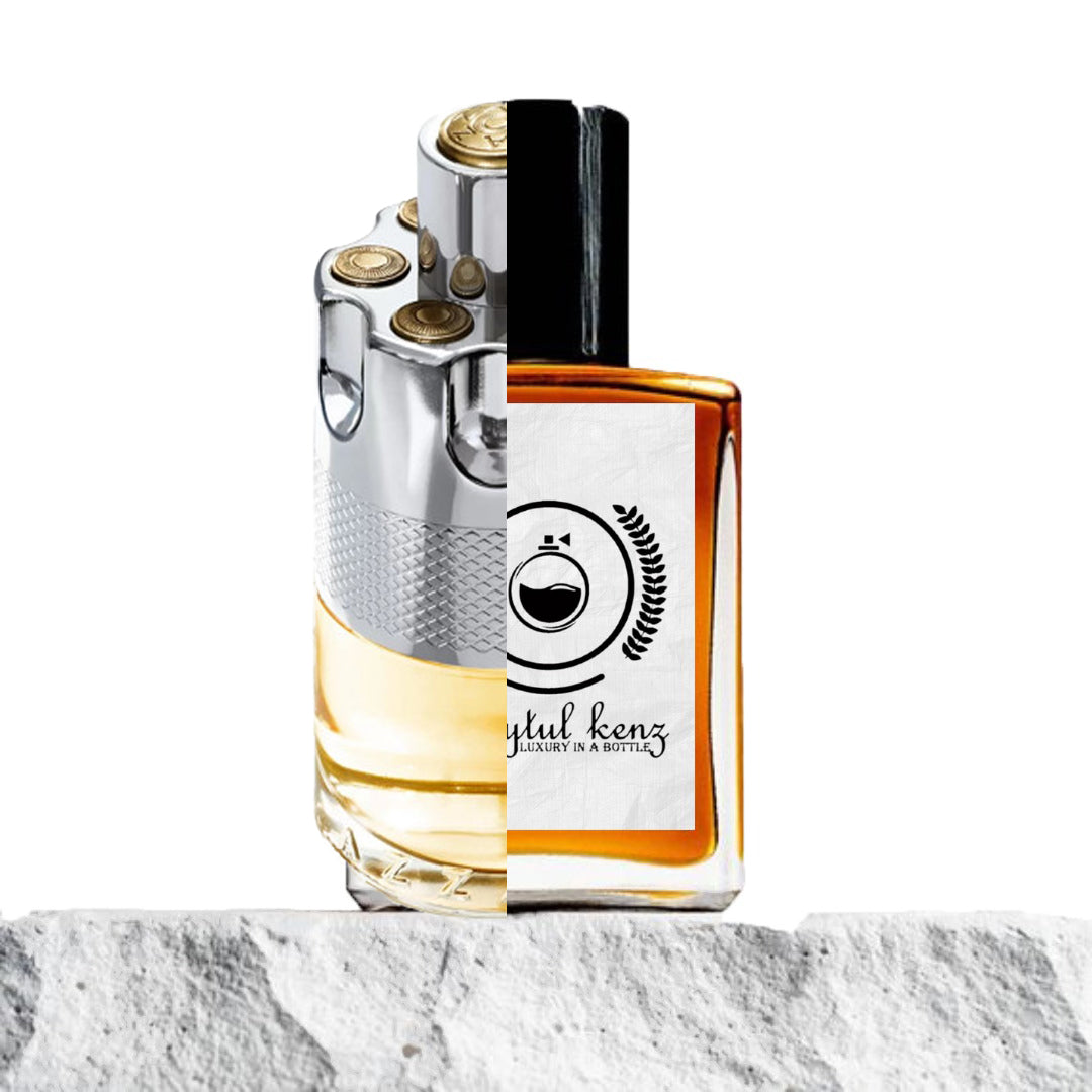 "Two perfume bottles are placed side by side on a textured background."
"On the left is a silver and gold colored bottle of Azzaro Wanted, featuring a sleek, metallic design with a circular shape."
"On the right is an amber-colored bottle of Baytulkenz, an inspired version of Azzaro Wanted, with a similar shape but in warm amber tones."
"Both bottles have intricate details, with the Azzaro bottle showcasing a polished, high-end look, while the Baytulkenz bottle has a slightly more muted, amber glow."